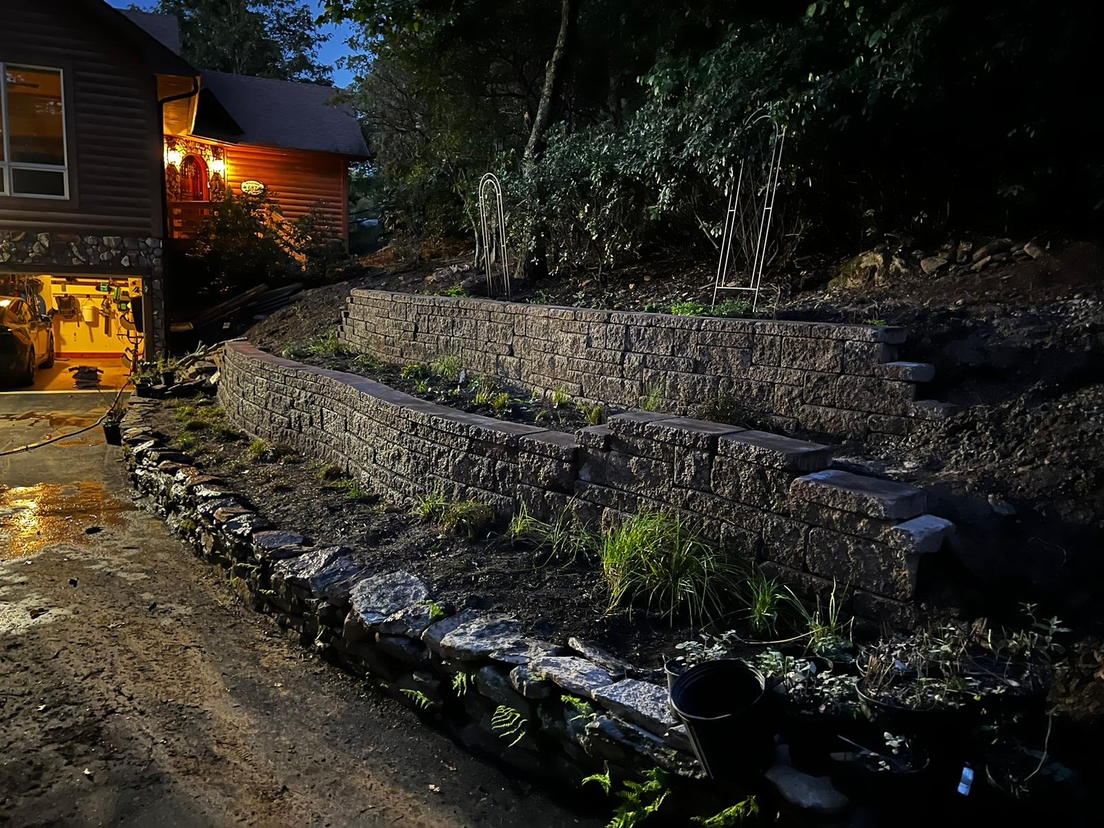 Tiered retaining wall along driveway at twilight Western NC