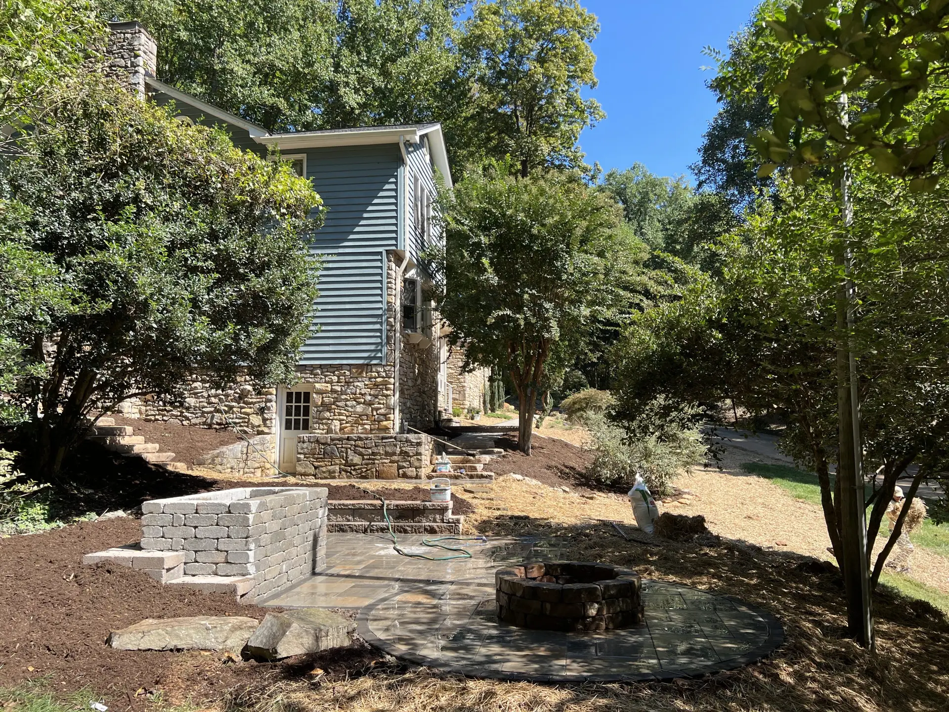 Fire pit with seating wall and outdoor countertop